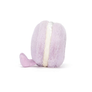 Side view of a Jellycat purple macaron shaped plush with purple feet on a white background. 