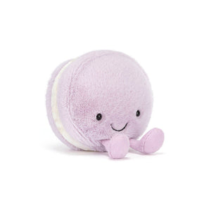 Jellycat purple macaron shaped plush with a smiling face and purple feet on a white background. 