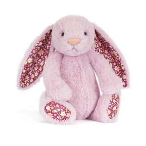 Jellycat lilac plush bunny with floral patterned ear lining and a white fluffy tail on a white background. 