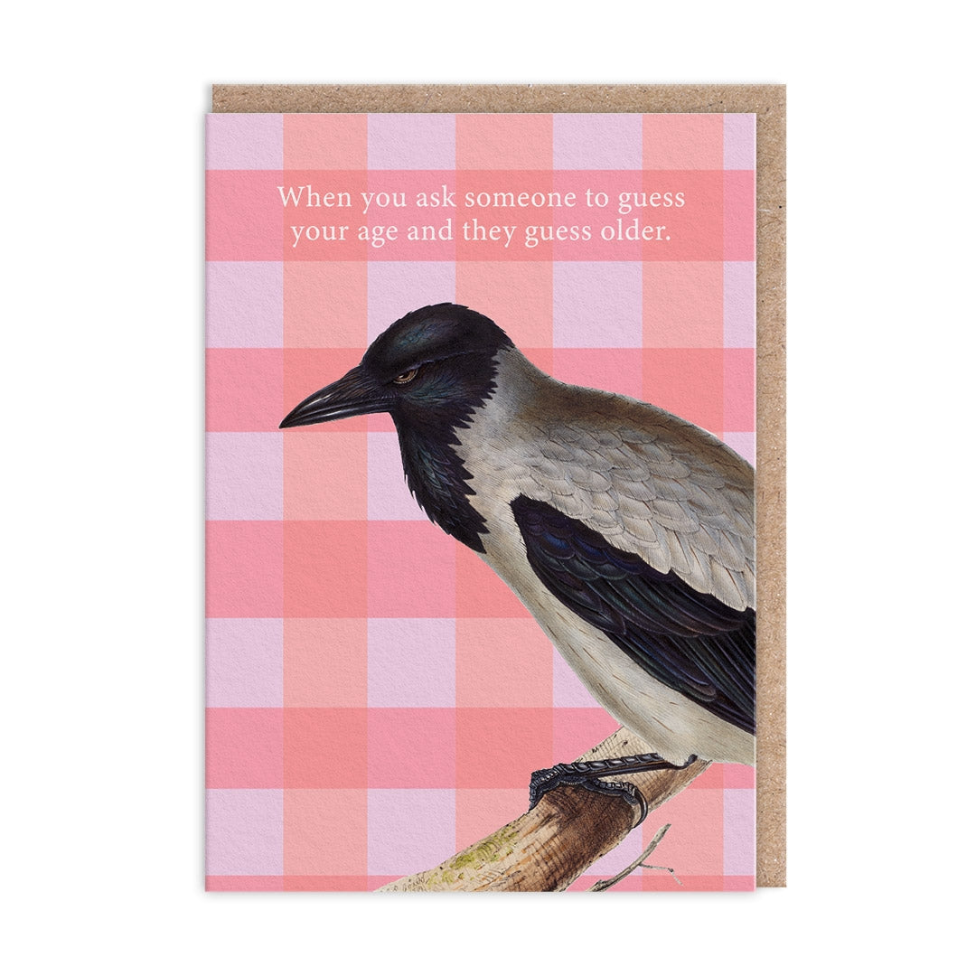 Greeting card with a black and white bird illustration and the text "When you ask someone to guess your age and they guess older." on a pink checkered background.