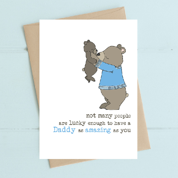 white father's day card with a grey bear wearing a blue sweater and holding up a bear cub. text below reads "not many people are lucky enough to have a Daddy as amazing as you"