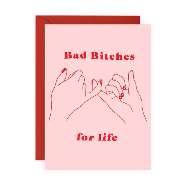 pink birthday card. two hands with painted nails linking pinky fingers. top text reads "bad bitches". bottom text reads "for life"