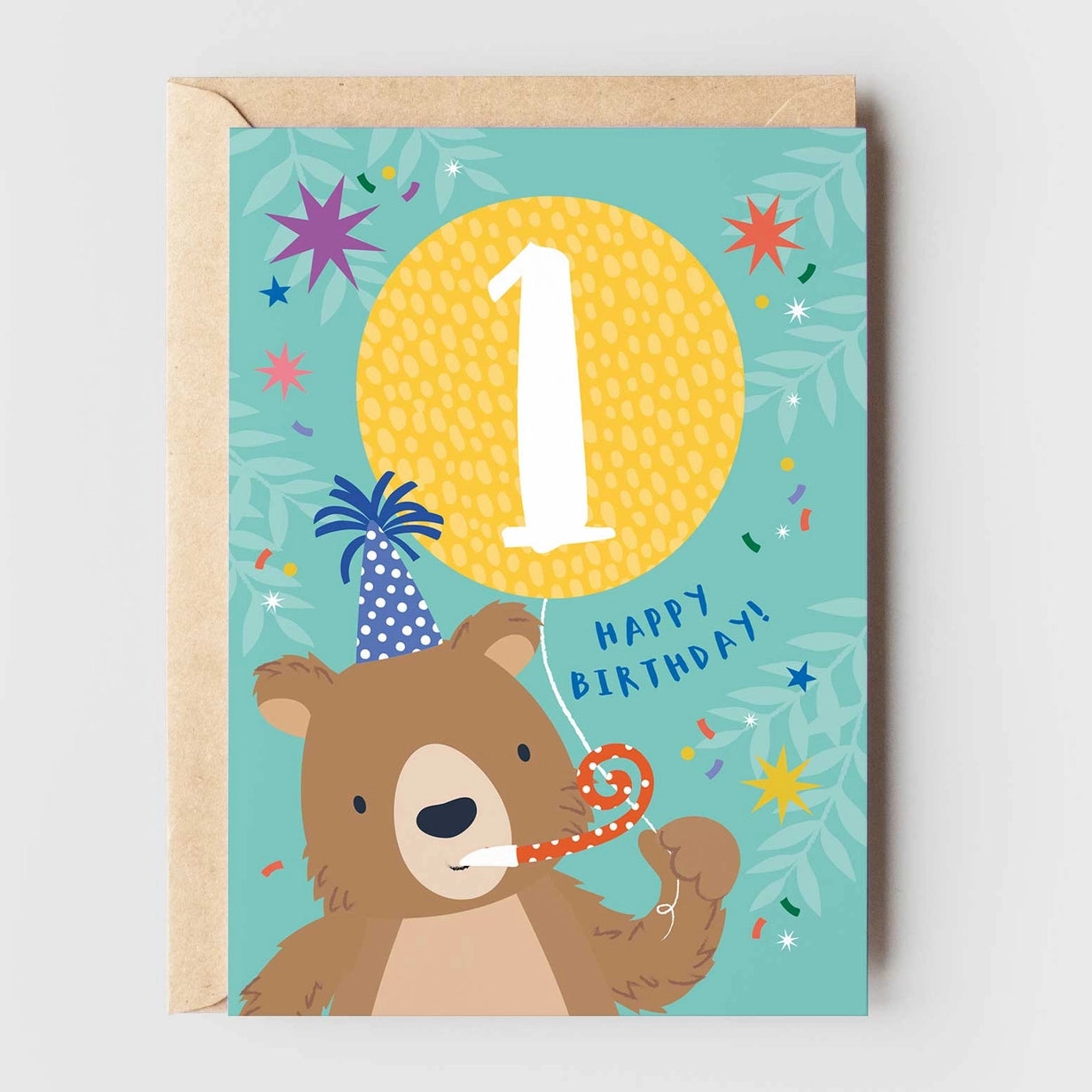 Greeting card featuring an illustration of a brown bear wearing a party hat, blowing a party blower and holding a yellow balloon on a blue background. The number '1' is printed on the balloon, while the text 'Happy Birthday!' is printed underneath.