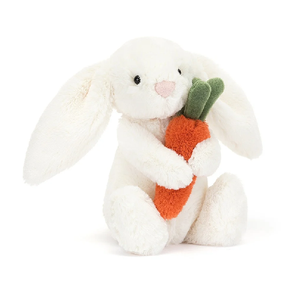 adorably soft plushie of a white bunny holding a carrot by popular brand Jellycat.