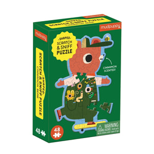 Mudpuppy scratch and sniff puzzle packaging featuring an image of a finished puzzle of a skateboarding bear on a green background.