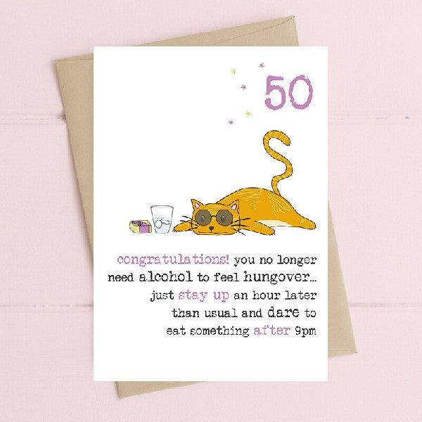 white birthday card with a number 50 on the top right and a cat on its stomach. it wears glasses and has a cup of water next to it. bottom text reads "congratulations! you no longer need alcohol to feel hungover... just stay up an hour later than usual and dare to eat something after 9pm"
