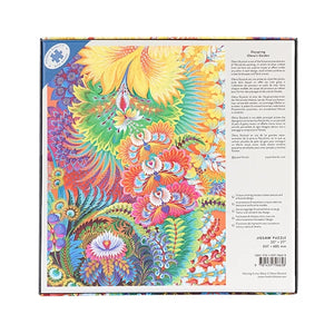 Back view of a jigsaw puzzle box with a colourful abstract floral design on a white background.