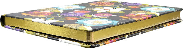 Decorative notebook with floral pattern and gold accents on a black background