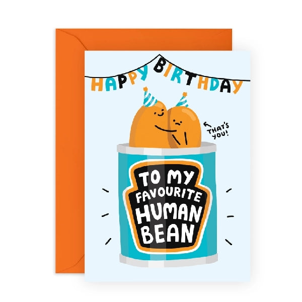 pastel blue birthday card. top text reads "happy birthday" in a garland. below is two beans sticking out of a can of beans, one smiling and hugging a sad one. both wear a birthday hat. "that's you" text points to the sad one. the label of the can reads "to my favourite human bean"