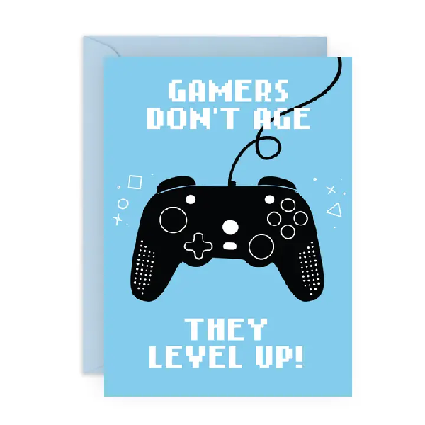 blue birthday card with a playstation controller in the centre. top text reads "gamers don't age". bottom text reads "they level up!"