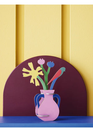 3D model shaped like a pink vase with blue handles containing colourful flowers and a bird. The model sits on a blue base with a purple arch behind it on a yellow background.