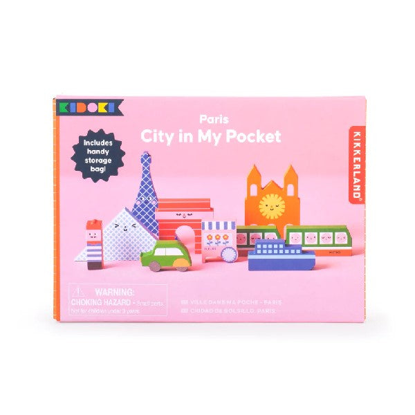 pink rectangular package on a white background. pictures on the box are smiling and winking colourful, Paris city-themed playing blocks. kikkerland product