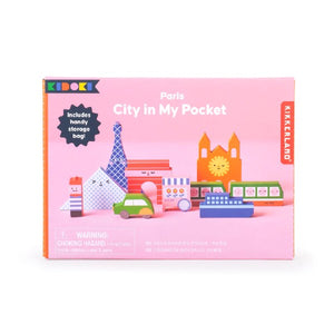 pink rectangular package on a white background. pictures on the box are smiling and winking colourful, Paris city-themed playing blocks. kikkerland product