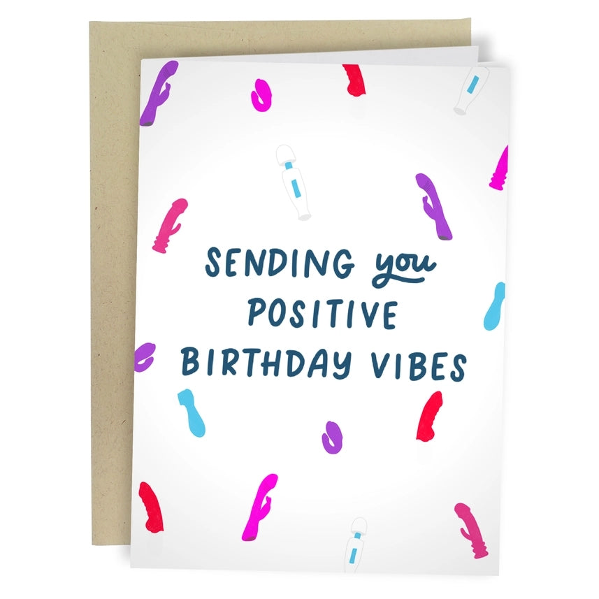 white birthday card. a variety of vibrators including wands, rabbits, and c-shape ones are around text. middle text reads "sending you positive birthday vibes"