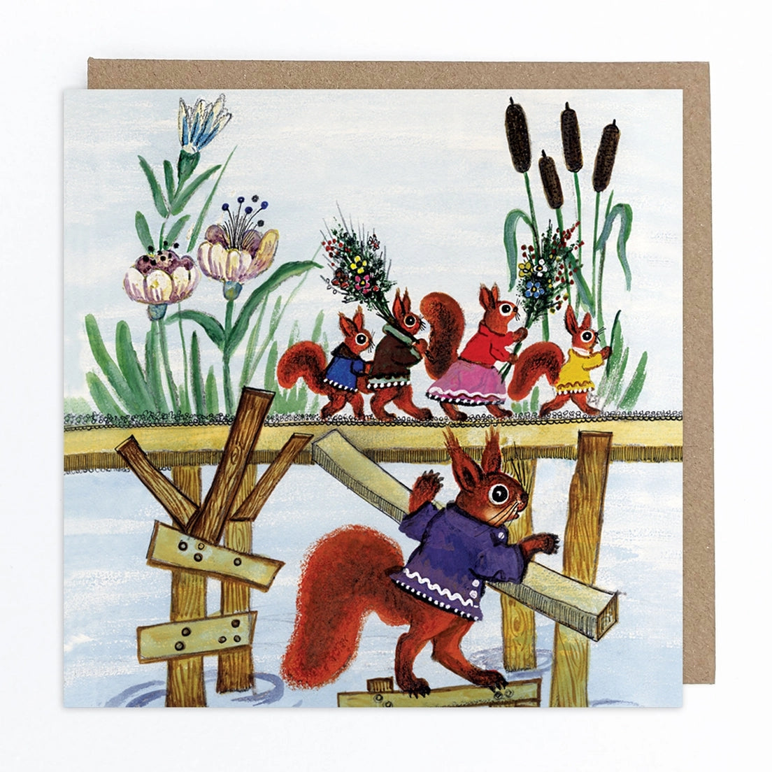 Card featuring a folk art style illustration of squirrels wearing colorful clothing as they walk along a wooden bridge carrying flowers.