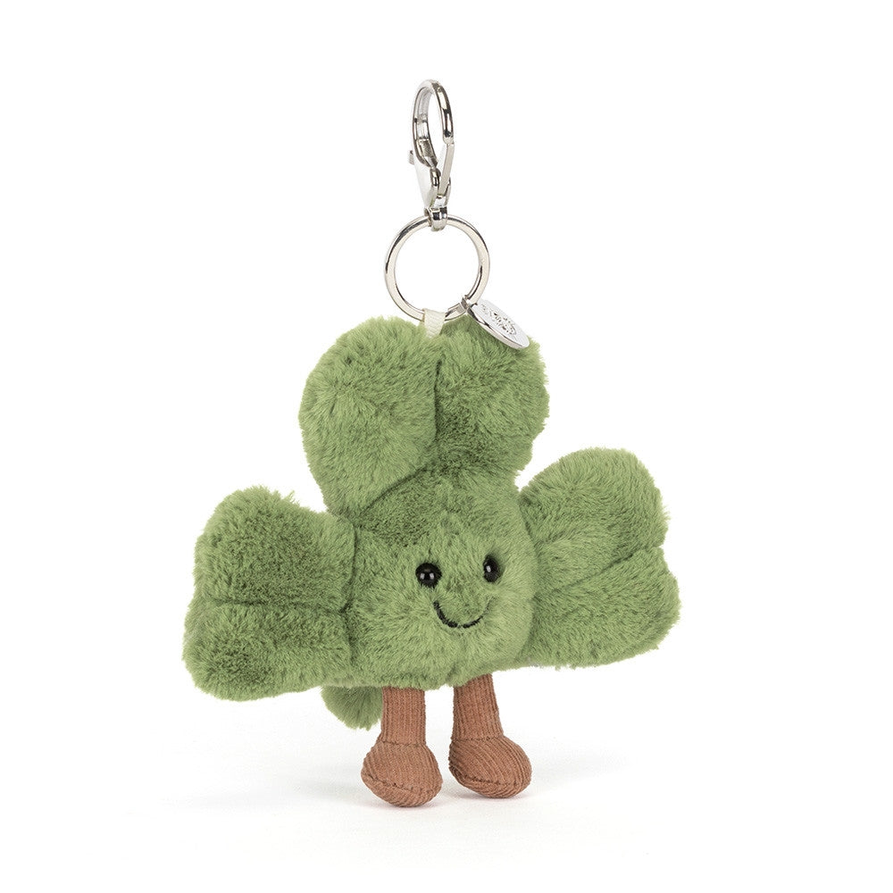 Front view of a Jellycat plush bag charm shaped like a green clover with a smiling face on a white background