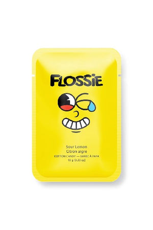 yellow rectangular bag with "Flossie" written in black and a cartoonish facial expression at the centre. the flavour of the candy is written in a smaller font below the grimace.