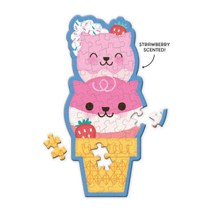 Finished puzzle in the style of a cone with two scoops of ice-cream in the shape of two smiling cat heads, two strawberries and some cream with sprinkles on top.