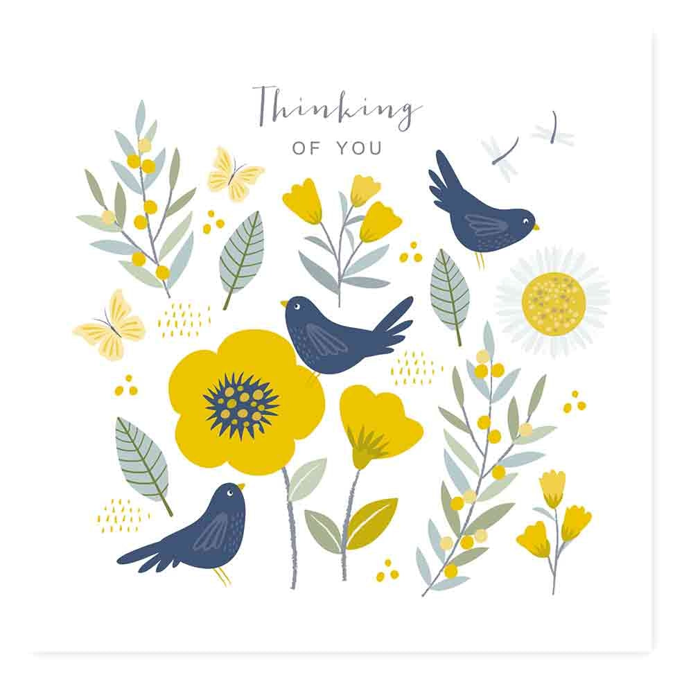 Greeting card featuring green, yellow and blue illustrations of birds, flowers, plants and a sun on a white background. The text 'Thinking of you' is printed over the design, 