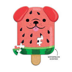 Finished puzzle in the style of a popsicle shaped dog with a watermelon coloured theme on a white background. The text 'Watermelon Scented' is placed beside the puzzle with an arrow pointing towards it.