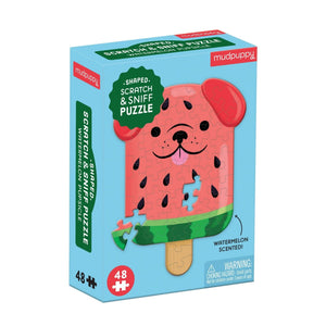 Mudpuppy watermelon popsicle puzzle packaging on a white background. The packaging features an image of the finished puzzle which is in the style of a popsicle shaped dog with a watermelon coloured theme. 