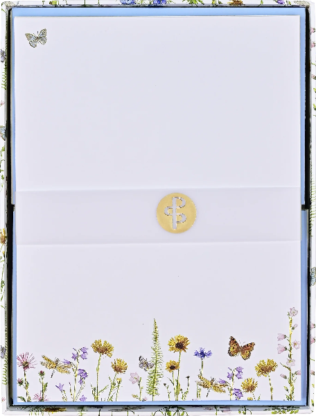 white blank card in a flowery box. the bottom of the card has flowers and butterflies. a single butterfly is at the top left of the card