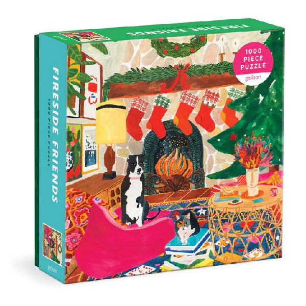 blue and grene puzzle box. the cover shows an illustration of a dog and a cat in front of a Christmas-ready fire place