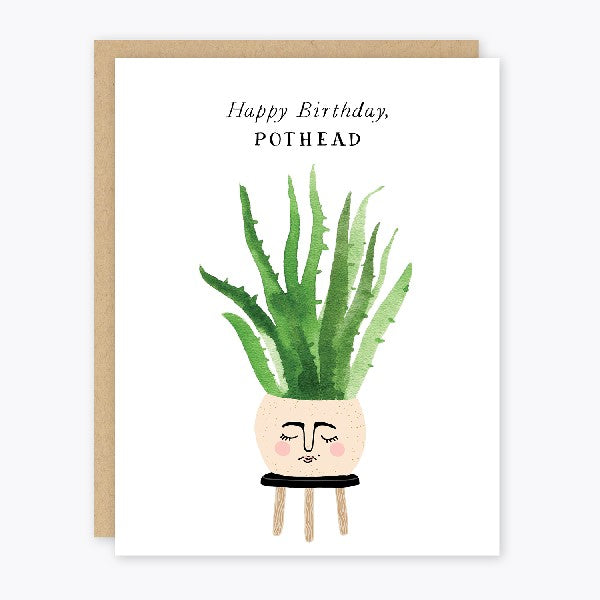 white birthday card. a watercolour illustration of a potted plant sits on a stool at the bottom of the card. a sleeping face is on the vase. top text reads "happy birthday, pothead"