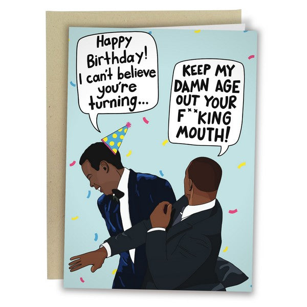 blue birthday card with a caricature of Chris Rock being slapped by Will Smith. Rock, wearing a birthday hat, says "happy birthday! i can't believe you're turning...". Smith says "keep my damn age out your f**king mouth!"